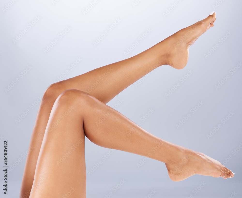 Legs, wellness and skincare for cosmetics, health or on grey studio background. Leg, grooming or smooth skin with soft, leg or self care for wellbeing, shaving or beauty for epilation at spa barefoot Legs, wellness and skincare for cosmetics, health or on grey studio background. Leg, grooming or smooth skin with soft, leg or self care for wellbeing, shaving or beauty for epilation at spa barefoot