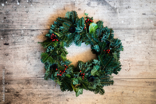 Studio shot of wreath made of spruce, juniper, ivy and rose hips
