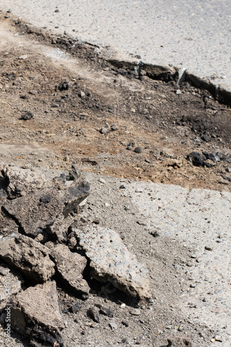 Destroyed road and fragments of asphalt, road repairs