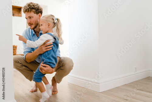 Young white father smiling and having fun with his daughter at home © Drobot Dean