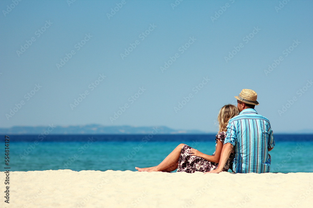 couple on the sand by the sea