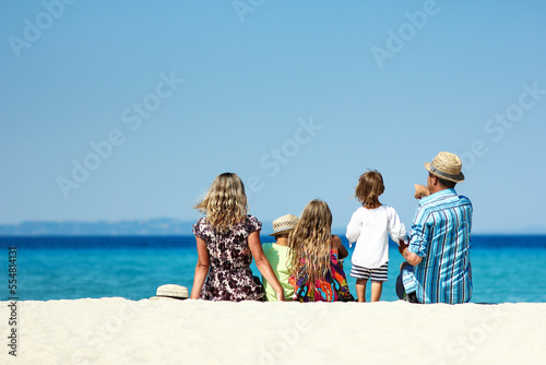 family on the sand by the sea