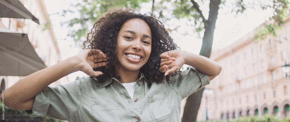 Happy african american student girl smiling in a city panoramic banner ...