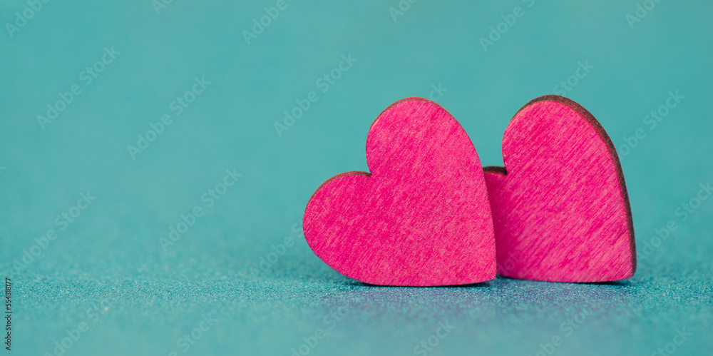 Obraz premium Pink hearts on a turqouise background, valentine greeting card, mothers day and birthday wishes, love symbol 