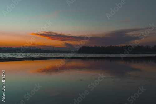 Beautiful winter view of the city of Dnipro during sunset or sunrise. Winter landscape. Ukrainian city. The lights of a sun. Calm nature copies the space background. © Denis Chubchenko