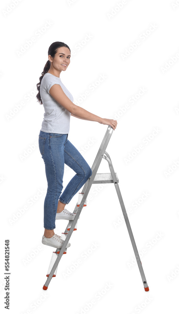 Young woman climbing up metal ladder on white background Young woman climbing up metal ladder on white background
