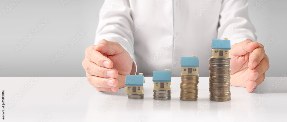 Fototapeta premium House Residential Structure in hand ,model house and coin