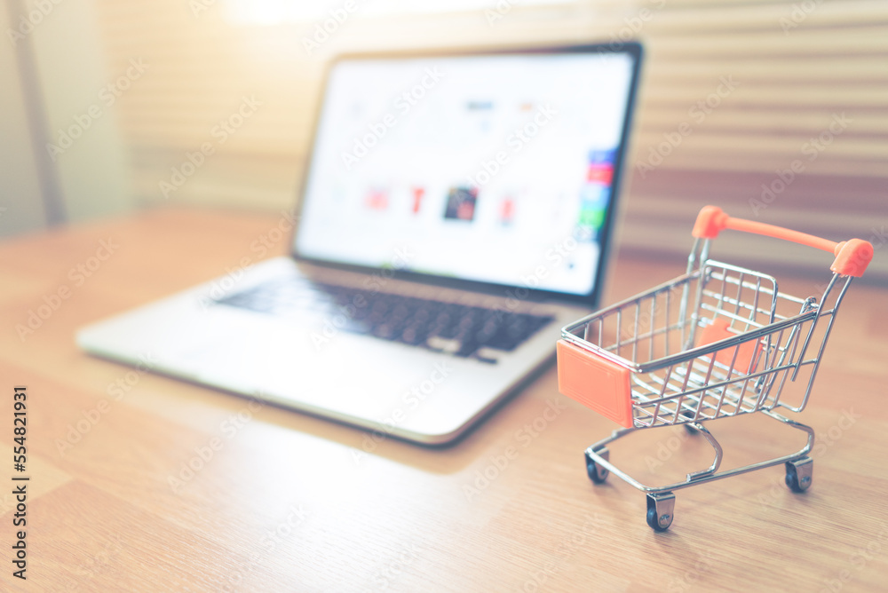 Shopping carts and laptop computers on the table used for online shopping.