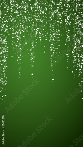 Magic falling snow christmas background. Subtle flying snow flakes and stars on christmas green background. Magic falling snow holiday scenery. Vertical vector illustration.