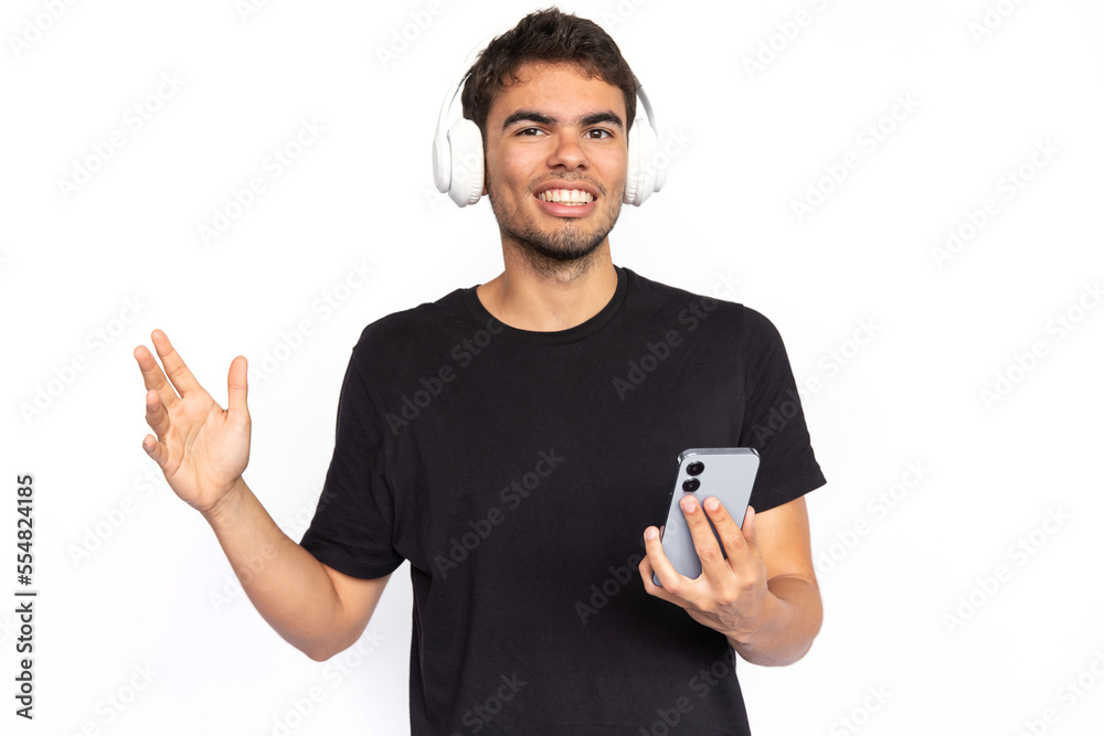 Excited young man with headphones and phone. Happy Caucasian male model with short dark hair in black T-shirt looking at camera, enjoying song or podcast. Modern technology, music concept Excited young man with headphones and phone. Happy Caucasian male model with short dark hair in black T-shirt looking at camera, enjoying song or podcast. Modern technology, music concept