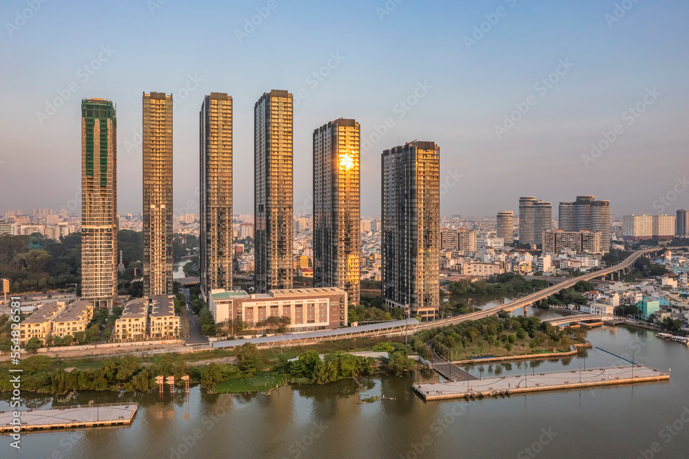 Obraz premium Top view aerial photo from flying drone of a Ho Chi Minh City with development buildings, transportation, energy power infrastructure. 