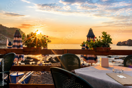 фотографія beautiful view from a restaurant terrace with tables, chairs and decoration flow