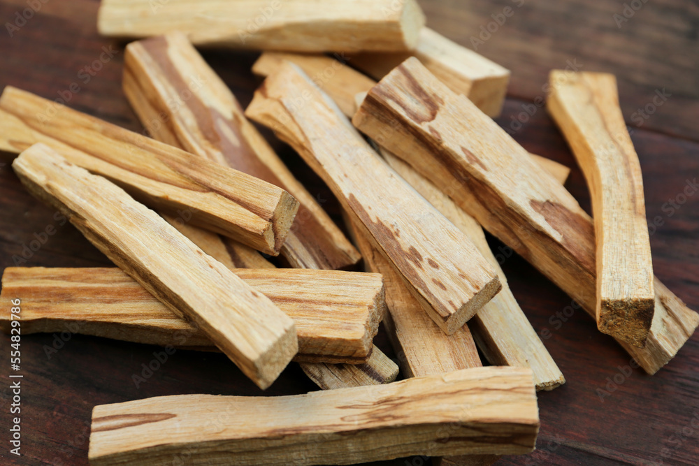 Many palo santo sticks on wooden table, closeup Many palo santo sticks on wooden table, closeup