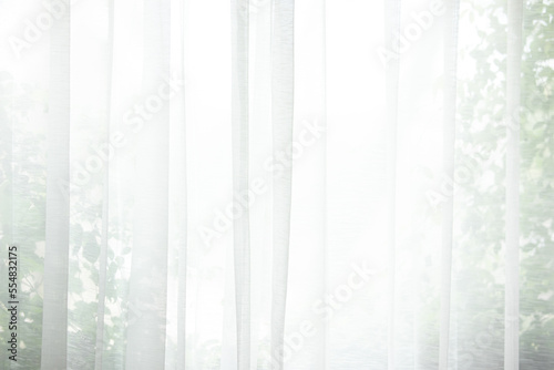 beautiful white curtain scene windows and curtain walls The light and shadow of the evening weather Warm colors that shine through silk curtains or curtains inside.