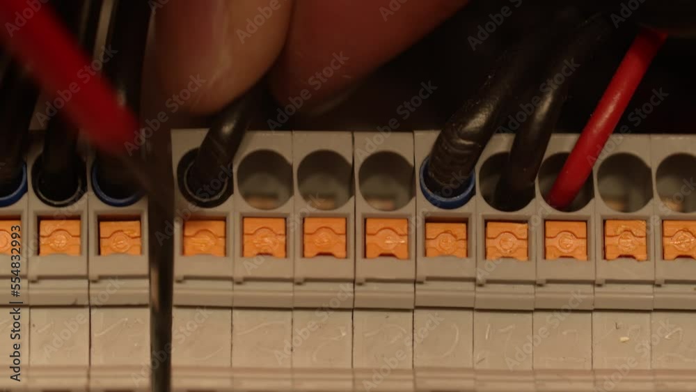 Electrical switch board. An engineer working on the electrical switch board
