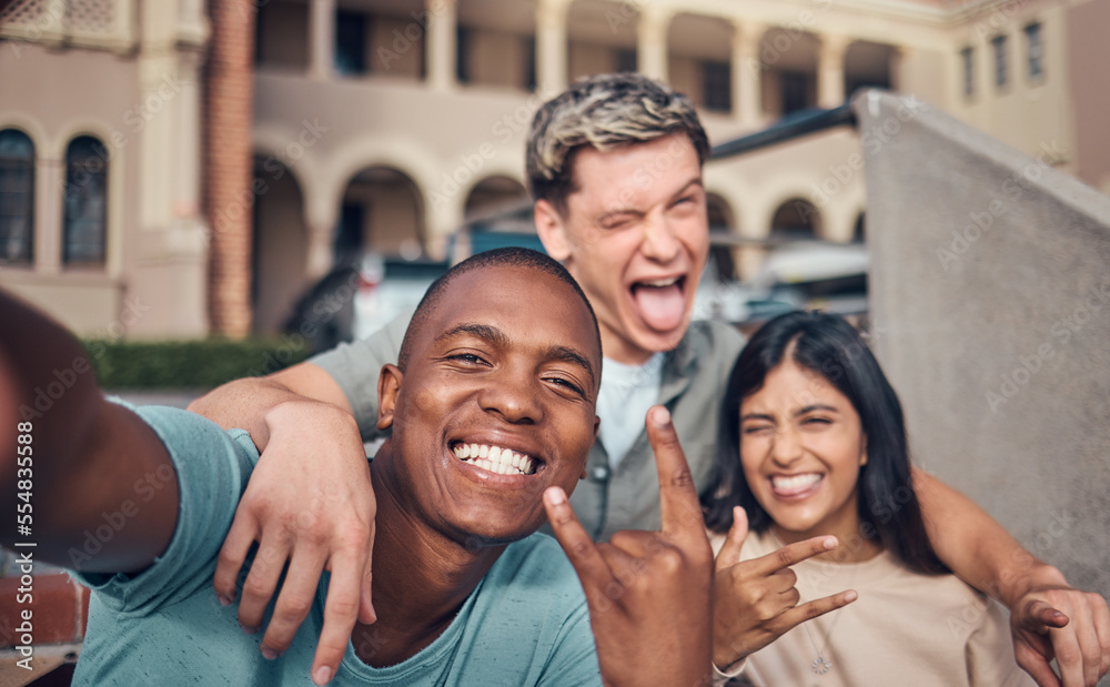 Fototapeta premium Friends selfie, smile and portrait on university campus with diversity, happy and funny face, hand gesture and rock sign. Happy, portrait and interracial college friendship, students and photograph