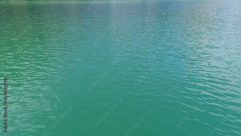 Turquoise water in a mountain forest lake with pine trees. Aerial view of blue lake and green forests. View on the lake between mountain forest. Over crystal clear mountain lake water. Fresh water Turquoise water in a mountain forest lake with pine trees. Aerial view of blue lake and green forests. View on the lake between mountain forest. Over crystal clear mountain lake water. Fresh water