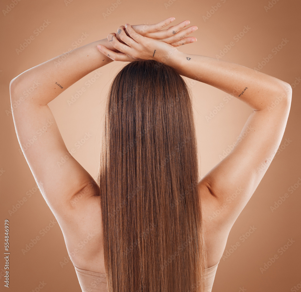 Naklejka premium Woman, hair and beauty in cosmetics studio with long hair, treatment and self care by brown background. Model, natural hair care and balayage for cosmetic, extension or wig by studio background