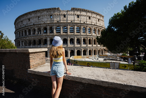 Photography Back of girl tourist enjoy view Colosseum in the old city center of Rome, Italy
