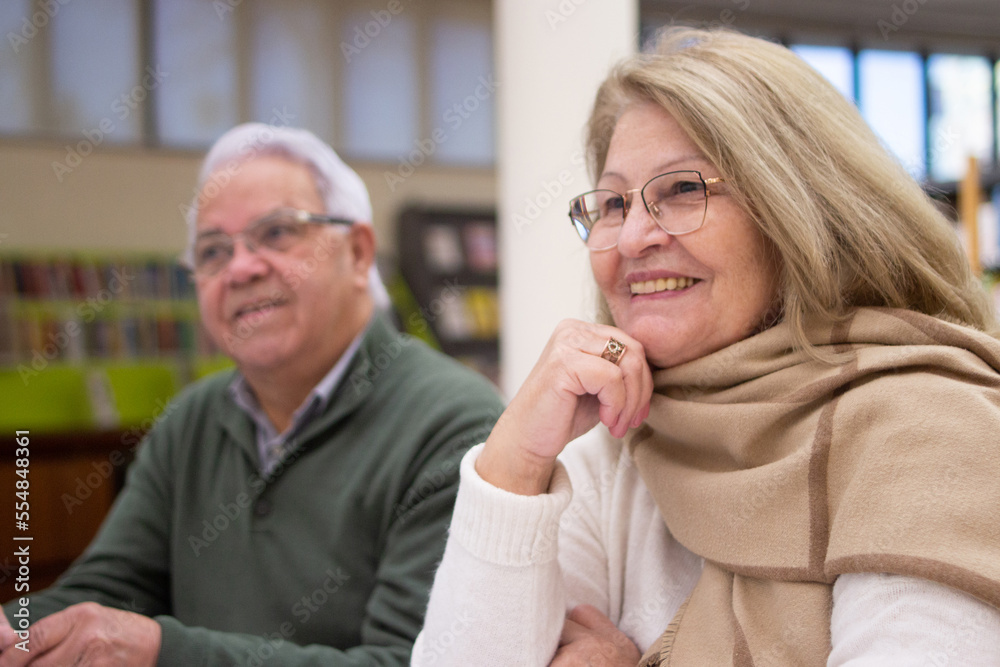 Portrait of happy elderly people attending study courses. Smiling man and woman listening to teachers lecture about modern technologies and enjoying life. Free time for study of mature people concept Portrait of happy elderly people attending study courses. Smiling man and woman listening to teachers lecture about modern technologies and enjoying life. Free time for study of mature people concept