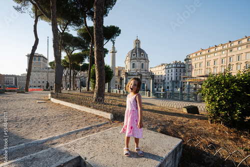 Baby girl against Santa Maria di Loreto church in Rome, Italy. photo