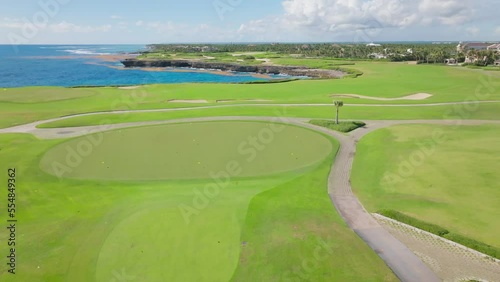 Drone flying over Corales Golf Course along coastline, Puntacana Resort and Club, Dominican Republic. Aerial forward photo