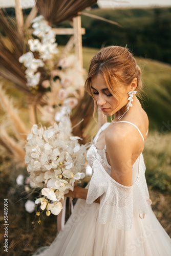 Young beautiful blonde bride in a wedding dress