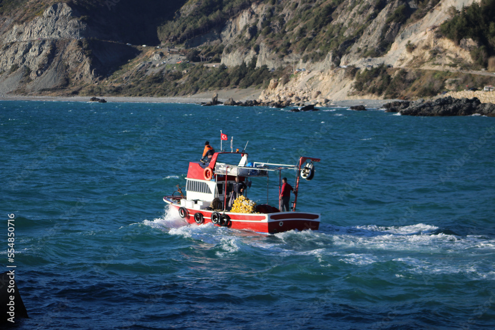 Fototapeta premium Red fishing boat on Mediterranean sea. Blue sea and sunny day.