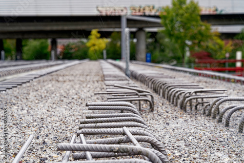 Obraz na plátně Open day at highway enclosure construction site with close-up of concrete girder with armoring irons at Zürich Schwamendingen on a rainy autumn day