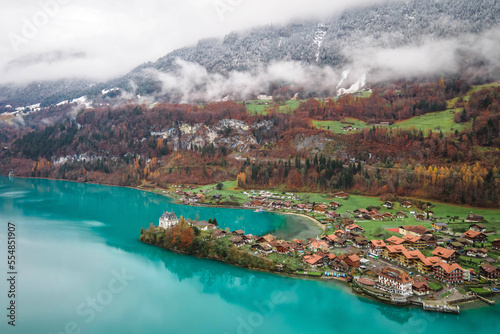 Fototapeta Naklejka Na Ścianę i Meble -  Aerial view, Iseltwald village with idyllic nature scenery of lake Brienz with turquoise waters. Switzerland