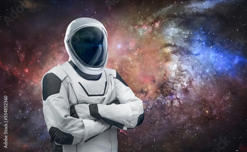 Fototapeta Naklejka Na Ścianę i Meble -  Astronaut stand on space background with stars. Spaceman in spacesuit. Cosmic sci-fi wallpaper. Elements of this image furnished by NASA