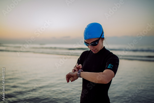Φωτογραφία Woman in neoprene chcecking smartwatch, after diving.