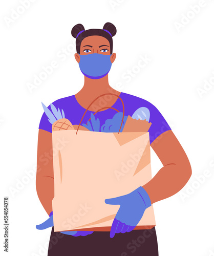 A girl in a face mask and gloves with a bag of groceries from the supermarket. Safe delivery of products from the supermarket. 