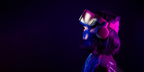 Woman in virtual reality goggle in neon colors.