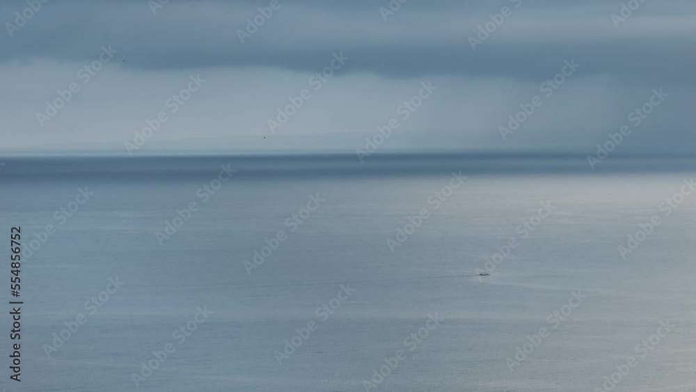 Small boat in front of dark clouds in the pacific. Bali - Indonesia. Small boat in front of dark clouds in the pacific. Bali - Indonesia.