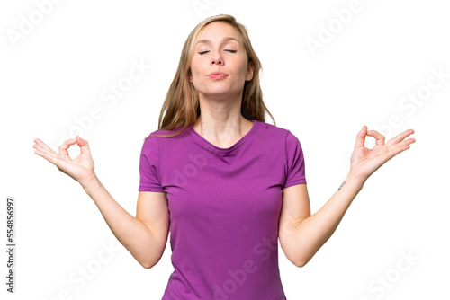 Young blonde woman over isolated background in zen pose © luismolinero