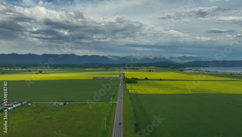 Aerial Panorama Of A Highway Through Kalispell Towards Bigfork County In Montana. Canola field photo