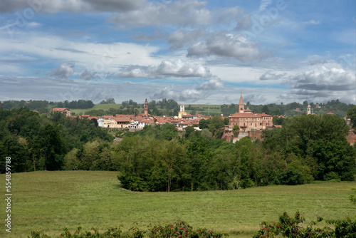 Cityscape of Bene Vagienna, Cuneo, Piedmont, Italy, with view landscape of the castle and the ancient bell towers between green fields and woods