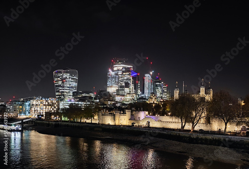 Night view of London part of the capital of Great Britain with the River Thames and the new skyscrapers of The City.