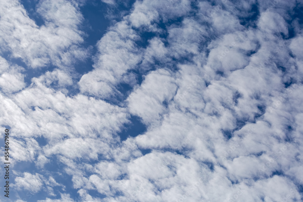 Patch of sky with floccus clouds at autumn day
