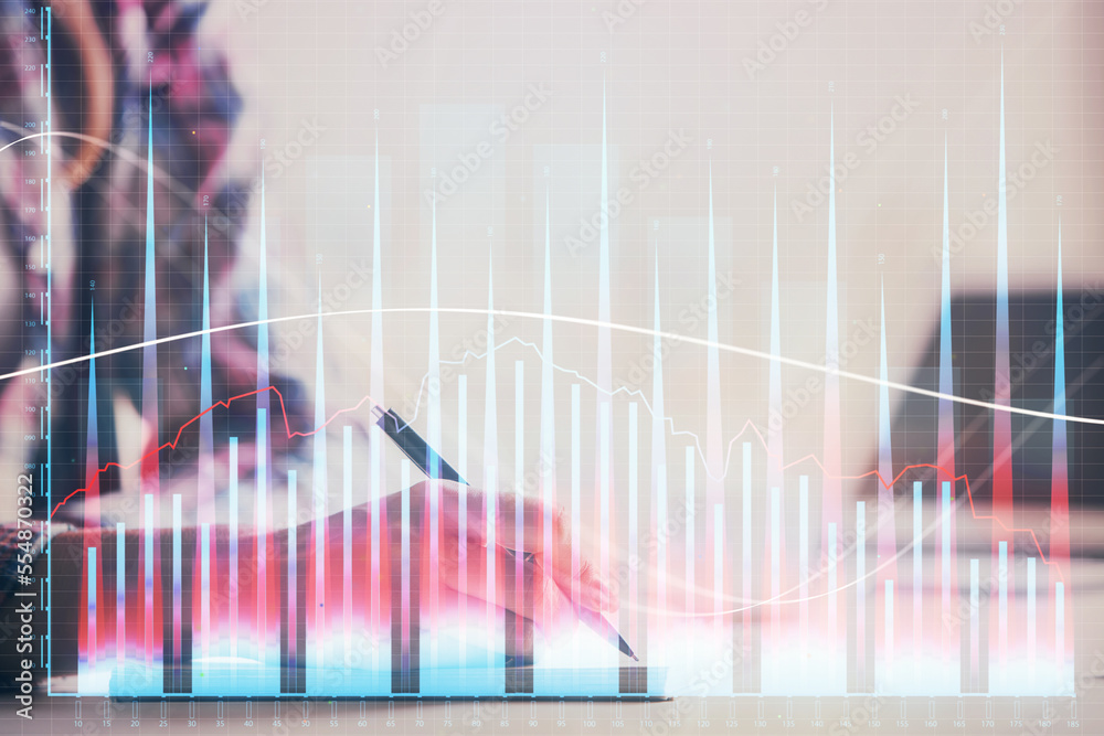 A woman hands writing information about stock market in notepad. Forex chart holograms in front. Concept of research. Double exposure A woman hands writing information about stock market in notepad. Forex chart holograms in front. Concept of research. Double exposure