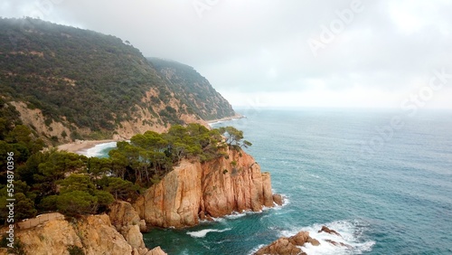 aerial view of the typical landscape of Costa Brava with cliffs at the mediterranean sea, beaches and mountains, coastline between Sant Feliu de Guíxols and Tossa de Mar, Canyet de Mar, Girona, Spain