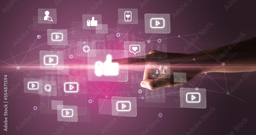 Hand pressing social media multimedia application screen with media icons on futuristic concept Hand pressing social media multimedia application screen with media icons on futuristic concept