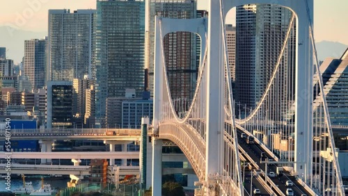 downtown Tokyo aerial view, suspension bridge in the capital of Japan, drone shot of Rainbow bridge in Odaiba, urban busy traffic in Asian metropolis