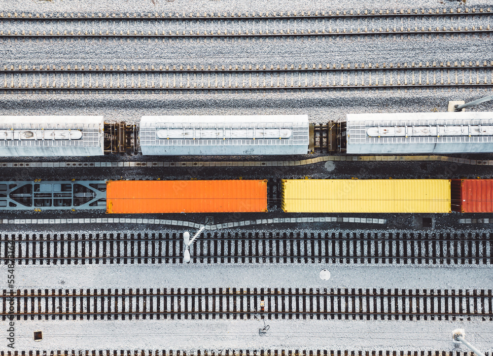 Top down view colorful wagons standing still parked on the railway lines Top down view colorful wagons standing still parked on the railway lines