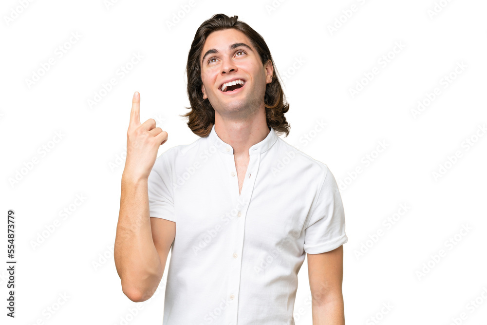 Young caucasian man isolated on green chroma background pointing up and surprised Young caucasian man isolated on green chroma background pointing up and surprised