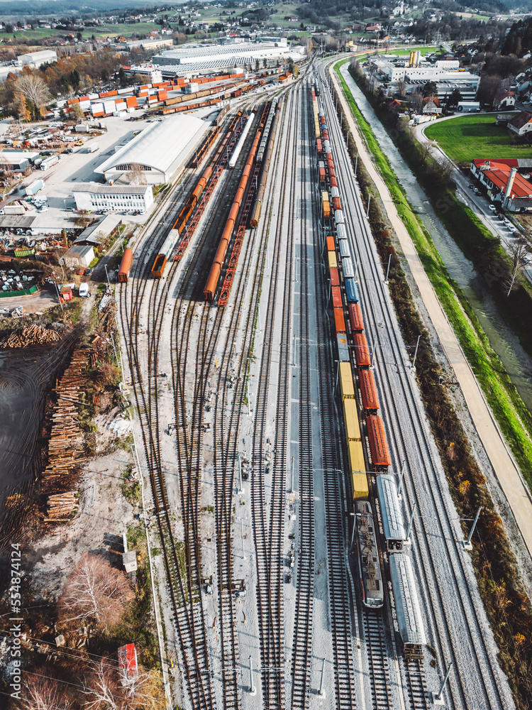 Vertical photo, aerial view of cargo trains standing still at the train station