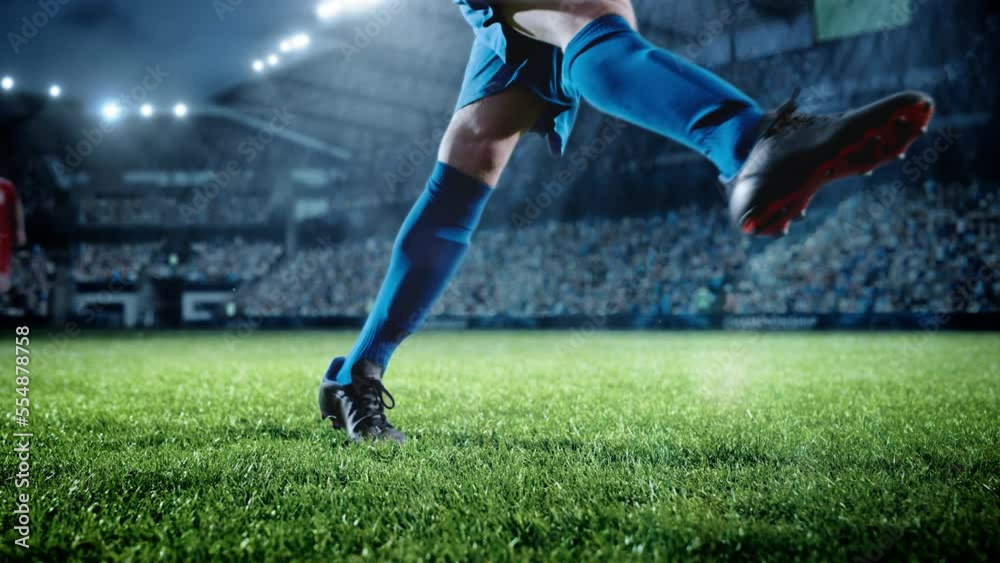 Football World Championship: Soccer Player Runs, Kicks the Ball. Ball Shoots, Grass Sprays Outwards, Full Stadium Crowd Cheers. Camera Moves in Arc Super Slow Motion. Cinematic Shot Captures Victory