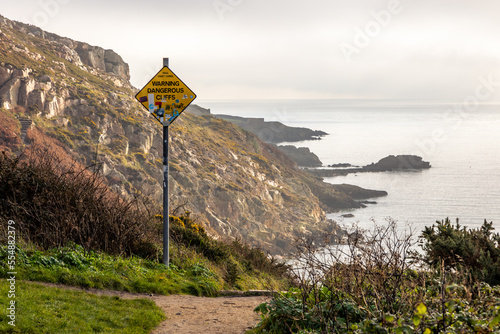 Canvas Print Warning sign for steep cliffs on hiking trail on Howth Island, Dublin, Ireland a