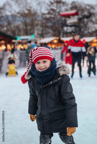 Boy skating on a rink at the Christmas market